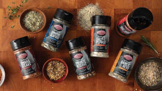 Bottles and bowls of Omaha Steaks seasonings on a cutting board