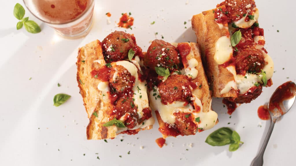 3 meatball marina sub sandwiches, each with three meatballs in marina sauce with melty cheese on top