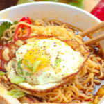 polynesian ramen with pork and topped with a fried egg