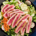 lettuce and sliced vegetables served with ahi tuna slices