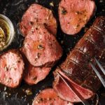 chateaubriand roast sliced with butcher's butter in bowl with serving spoon