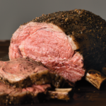 Bone-in frenched prime rib roast cooked and sliced