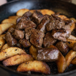 steak bites and fries in pan