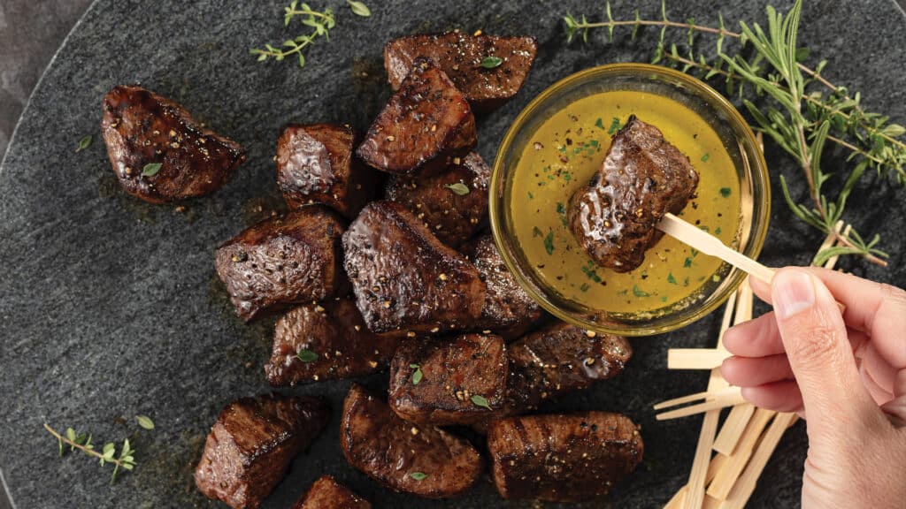 Steak bites served with garlic-herb butcher's butter