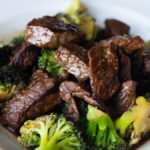 Kung pao broccoli beef in white bowl