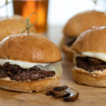 Philly cheeseburgers made with Omaha Steaks ground beef sliders, cooked mushrooms, provolone cheese and slider buns.