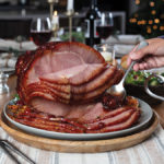 Rum and Coke glazed holiday ham on a holiday table