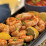 Air fried shrimp served with cocktail sauce and lemon wedges