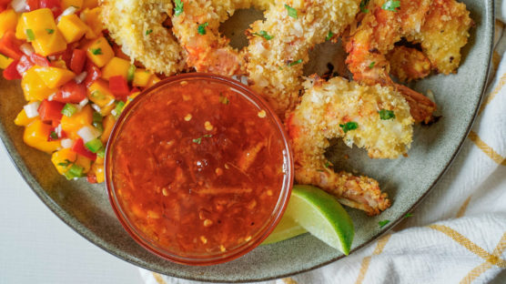 Air Fryer Coconut Shrimp served on a plate with dipping sauce