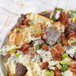 Crispy fries with air-fried sirloin beef tips, bleu cheese crumbles, bacon crumbles, green onion drizzle with a bleu cheese sauce.