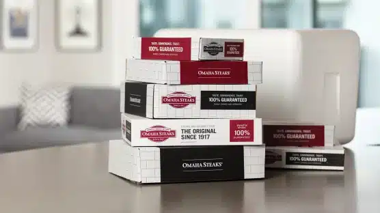 Omaha Steaks white cooler on counter with 7 Omaha Steaks boxes of different sizes