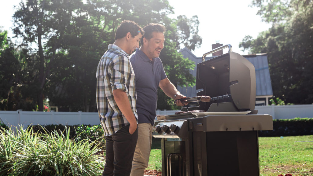 dad and son grilling outside