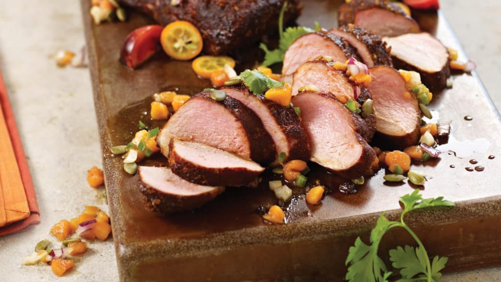 Ancho Chili Rubbed Pork Tenderloins with Fresh Papaya & Pepita Salsa on tray
