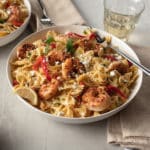 blackened shrimp pasta on white plate