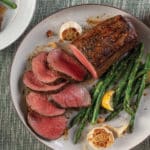 Roasted Chateaubriand with Red Wine Gravy and Lemon-Garlic Asparagus on plate