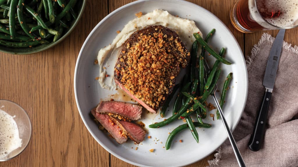 Parmesan-Crusted Ribeye with Garlic Mashed Potato Purée and Wok-Fried Green Beans on plate