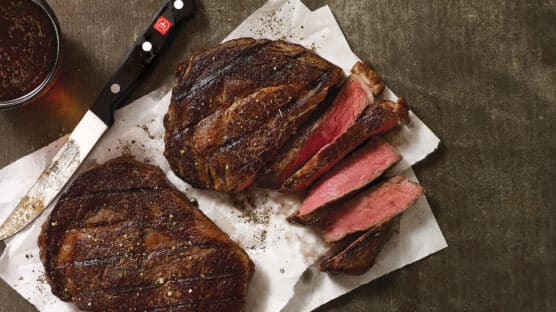 blackened steaks on cutting board