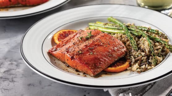 blood orange glazed salmon with rice on a plate