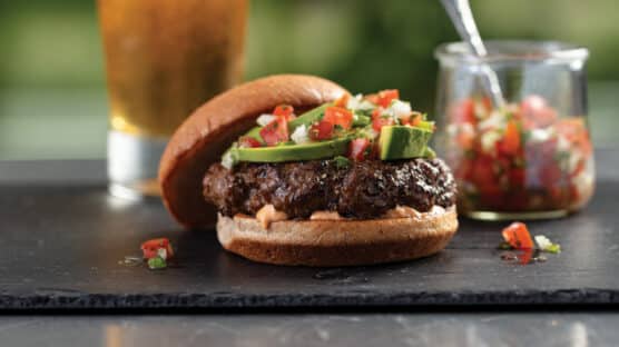 Southwestern Chipotle Burger with Chipotle Mayonnaise and Pico de Gallo on plate