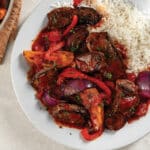 Lomo Saltado with red peppers and onions served with white rice