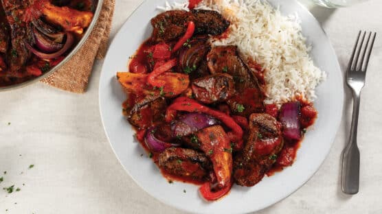 Lomo Saltado with red peppers and onions served with white rice