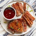 New York Strip steak plated and served with Gochujang sauce.