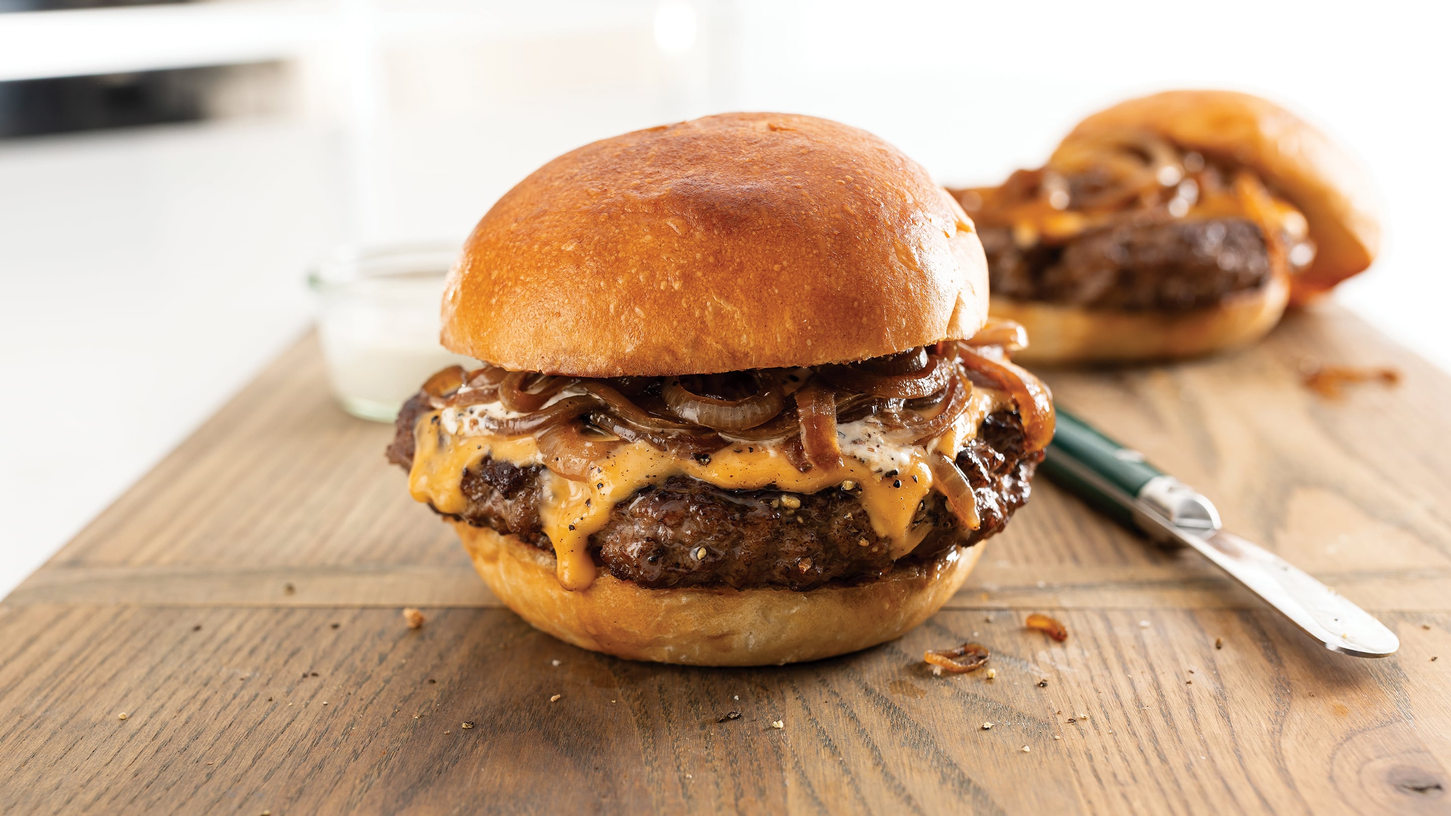 Butter burgers on a board.