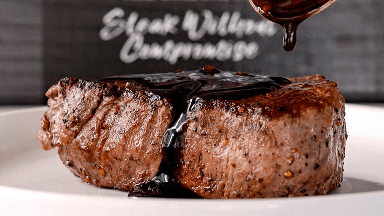 Spooning a balsamic pan sauce over a cooked Omaha Steaks USDA Certified Very Tender filet mignon steak.