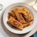 White plate with 3 bourbon peach salmon fillets