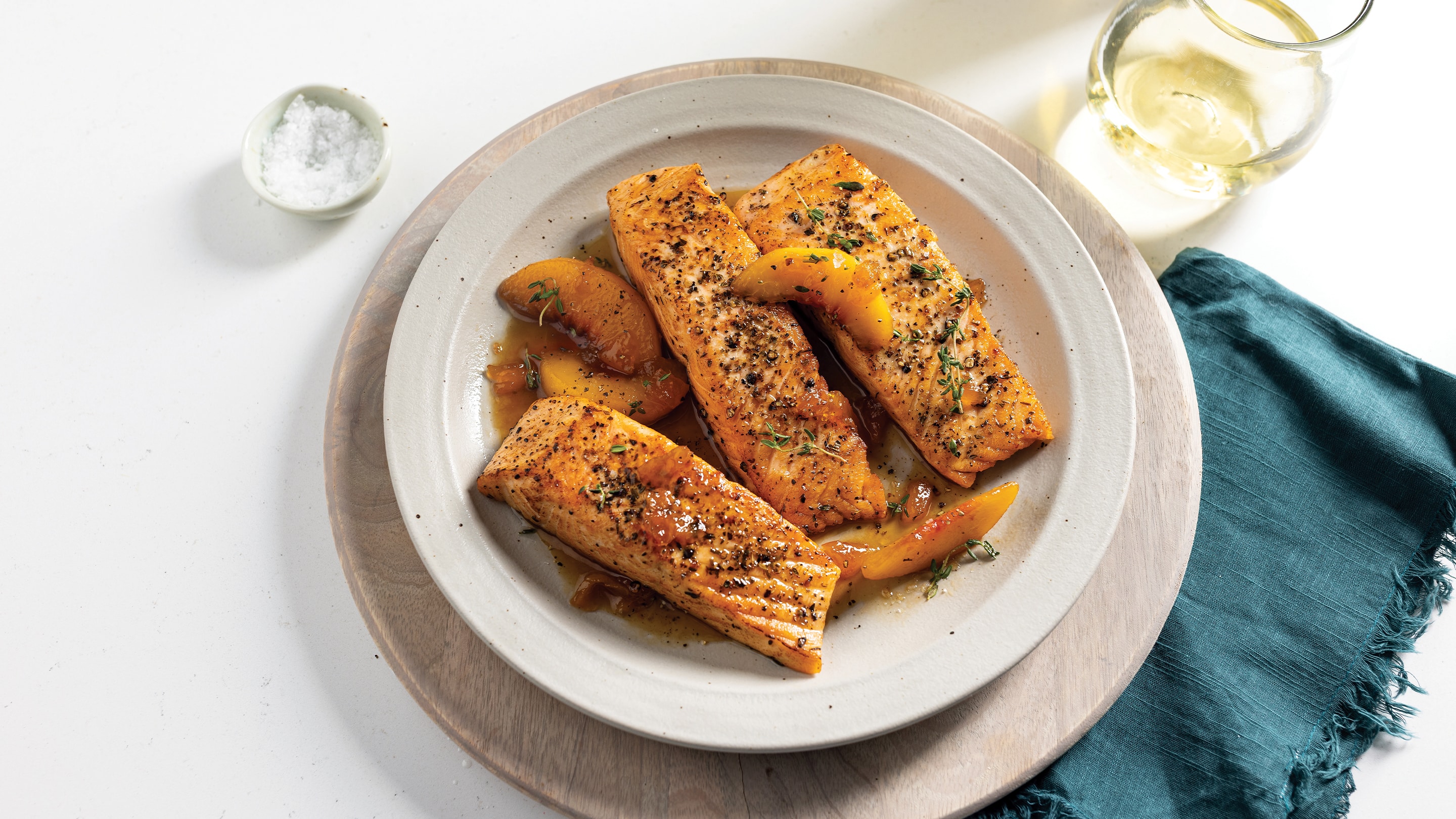 White plate with 3 bourbon peach salmon fillets