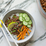 Korean ground beef and rice topped with pickled carrots, sliced cucumber, scallions and sesame seeds.