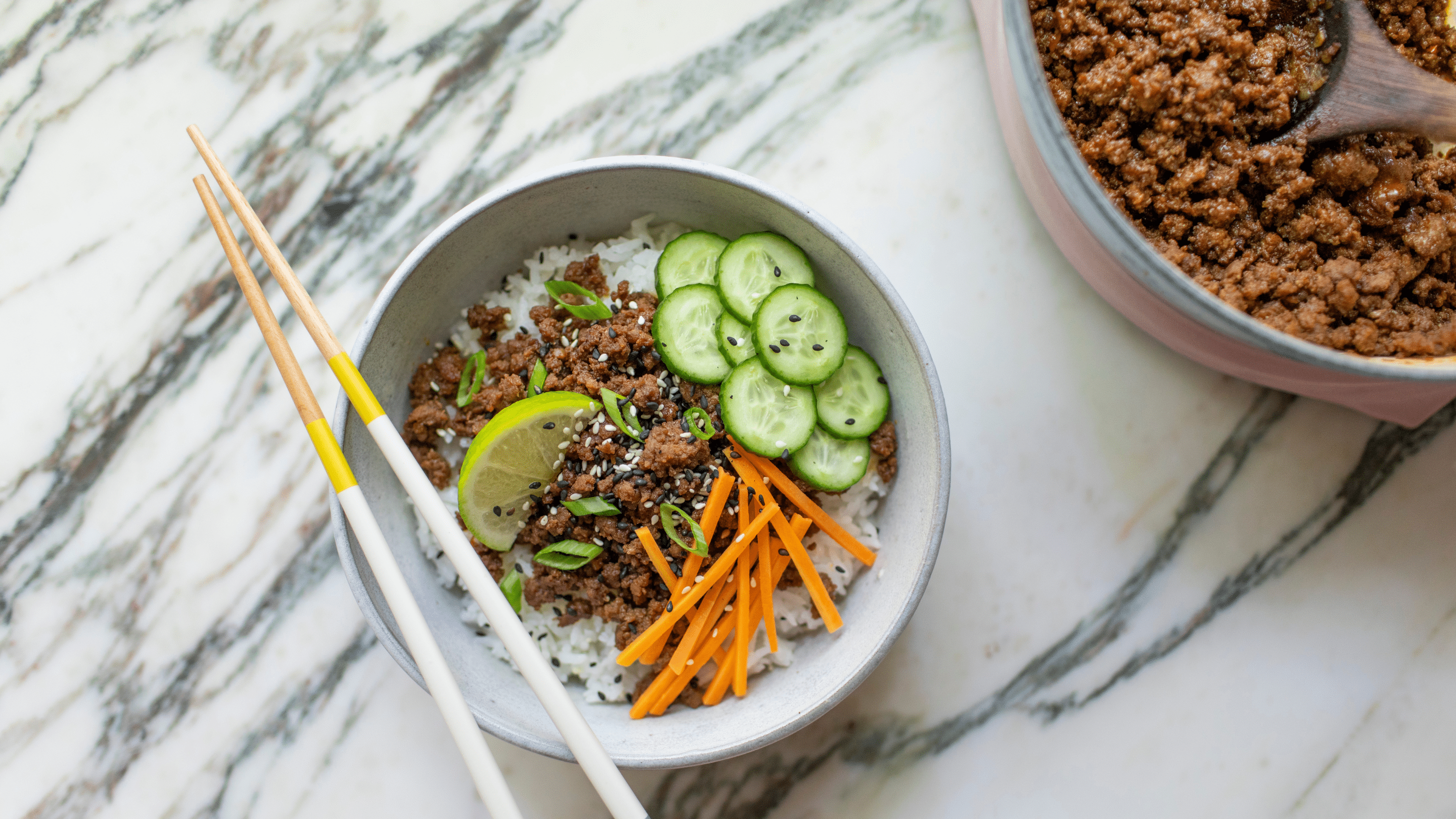 Korean ground beef and rice topped with pickled carrots, sliced cucumber, scallions and sesame seeds.