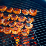 4 skewers on grill with shrimp and kielbasa