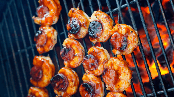 4 skewers on grill with shrimp and kielbasa