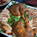 Thanksgiving table spread with grilled turkey, dressing, and cranberry sauce.