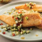 Plate with 3 pan-seared tilapia fillets topped with green apple chili sambal.