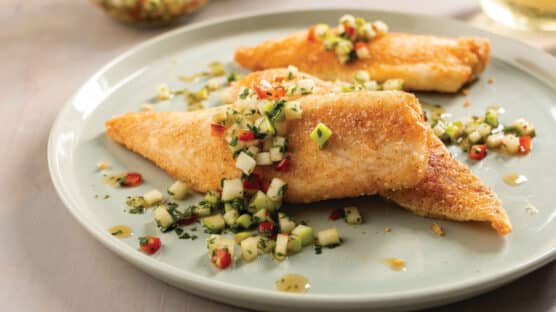 Plate with 3 pan-seared tilapia fillets topped with green apple chili sambal.